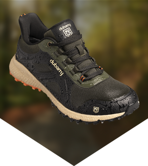Black and green hiking shoe with Dubarry branding on a blurred natural background