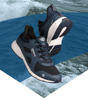 Black and white sneakers with visible brand logo on a water background