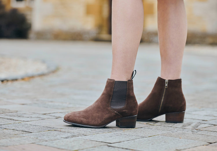 Image of a model wearing a pair of Dubarry Bray Chelsea boots for women, cigar brown coloured leather with elasticated side gussets with front and heel finger pulls