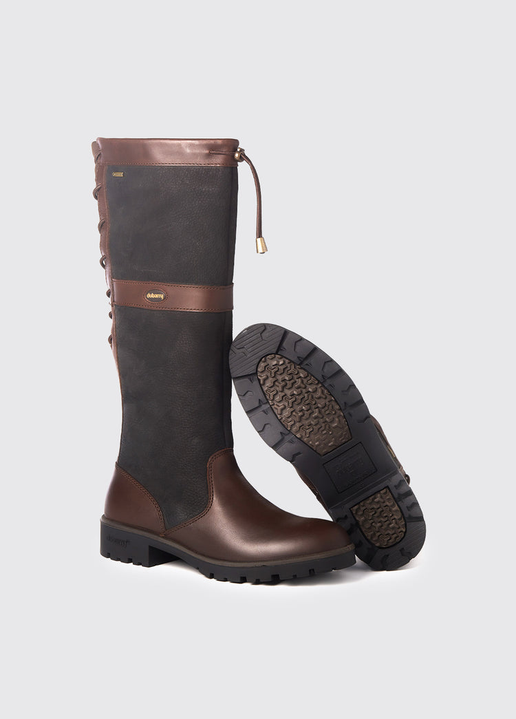 Pair of Dubarry ladies adjustable calf Glanmire Country Boot, knee high black and brown leather heeled boots with elasticated back and laced top, displayed to show one boot's sole