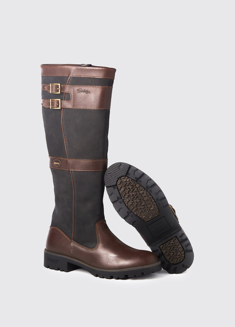 Pair of Dubarry Longford Country Boot, knee high black and brown leather heeled boots with buckles, displayed to show one boot's sole