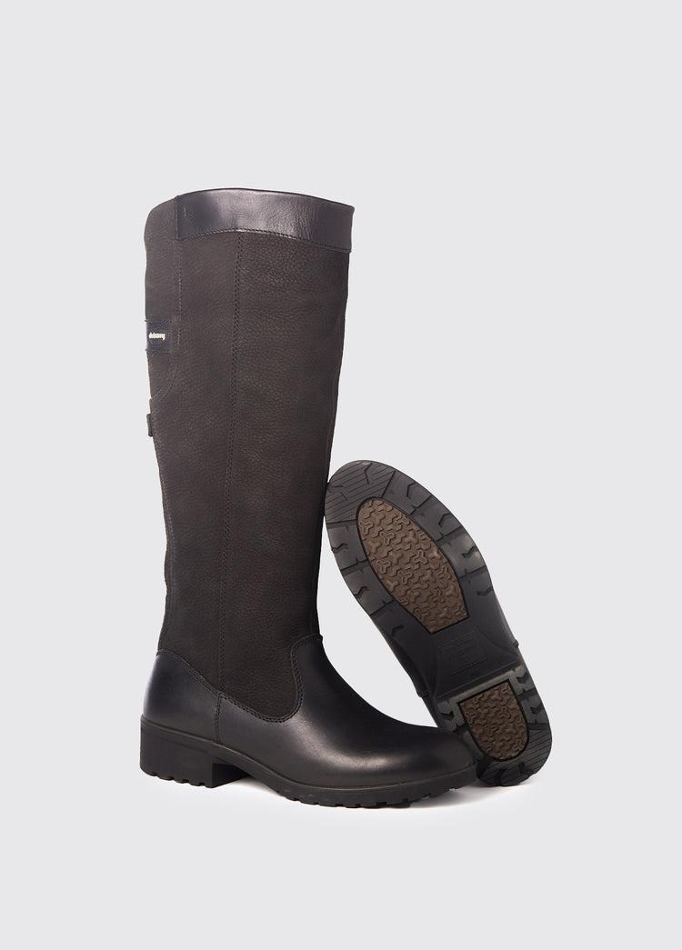 Pair of black Dubarry Clare leather country boots, knee high length, positioned to show one boot's sole