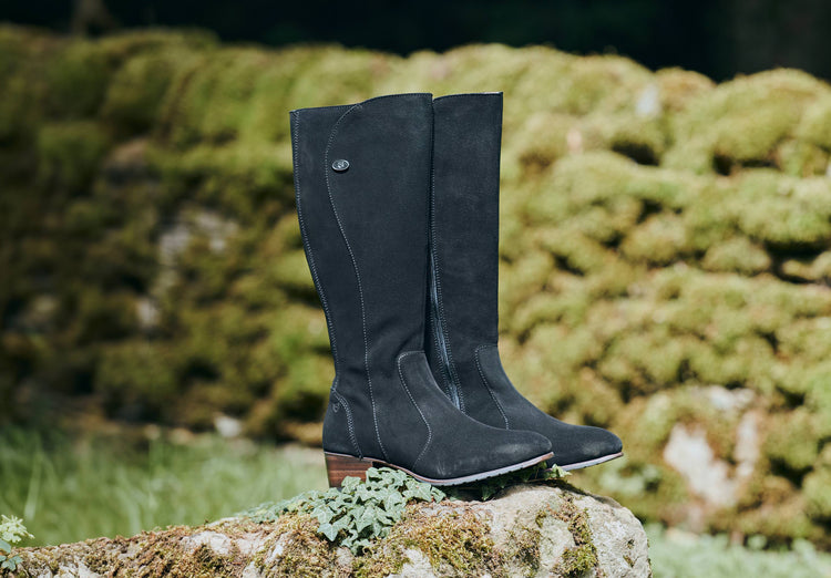 Outdoor image of a pair of Ladies Dubarry knee-high Black Suede Downpatrick Country Boot with Full length zip fastening.