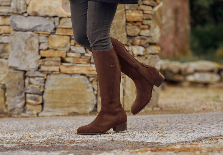 Outdoor on model image of a pair of Ladies Dubarry knee-high Cigar Downpatrick Country Boot with Full length zip fastening.