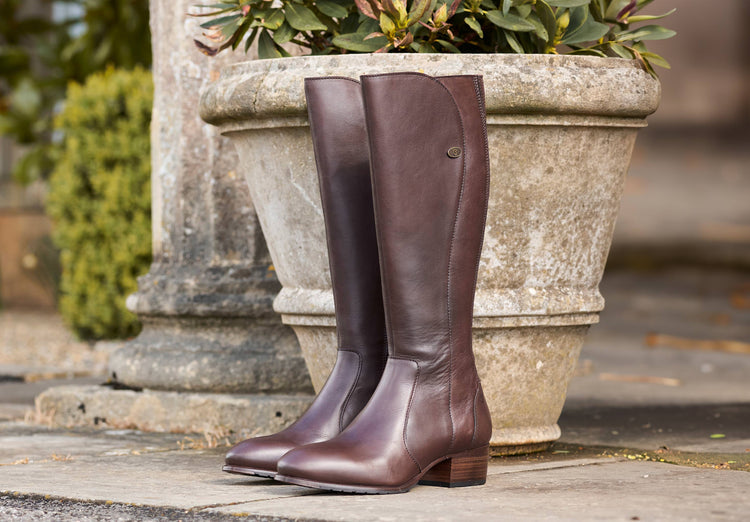 Outdoor image of a pair of Ladies Dubarry knee-high Old Rum Downpatrick Country Boot with Full length zip fastening.