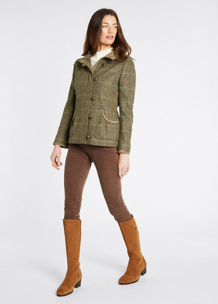 A woman modelling Dubarry women's Bracken Tweed thistle Coat with metal buttons and high collar. 