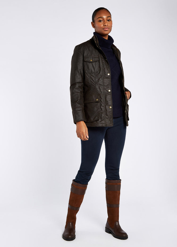 Waist up view of a Verdigris Dubarry Munsboro wax jacket, high collared jacket with golden buttons, pockets and full zip