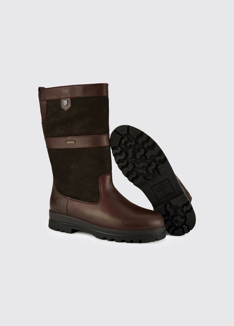 A pair of Dubarry Donegal mens  Country Boots, black and brown leather ski style boot with finger pull, boots are positioned to show one boot's sole