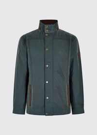 Waist up view of a male model wearing a Dubarry Carrickfergus waxed jacket open, dark pebble green blue coloured with a standing collar and buttons along the full zip and lighter brown inside collar